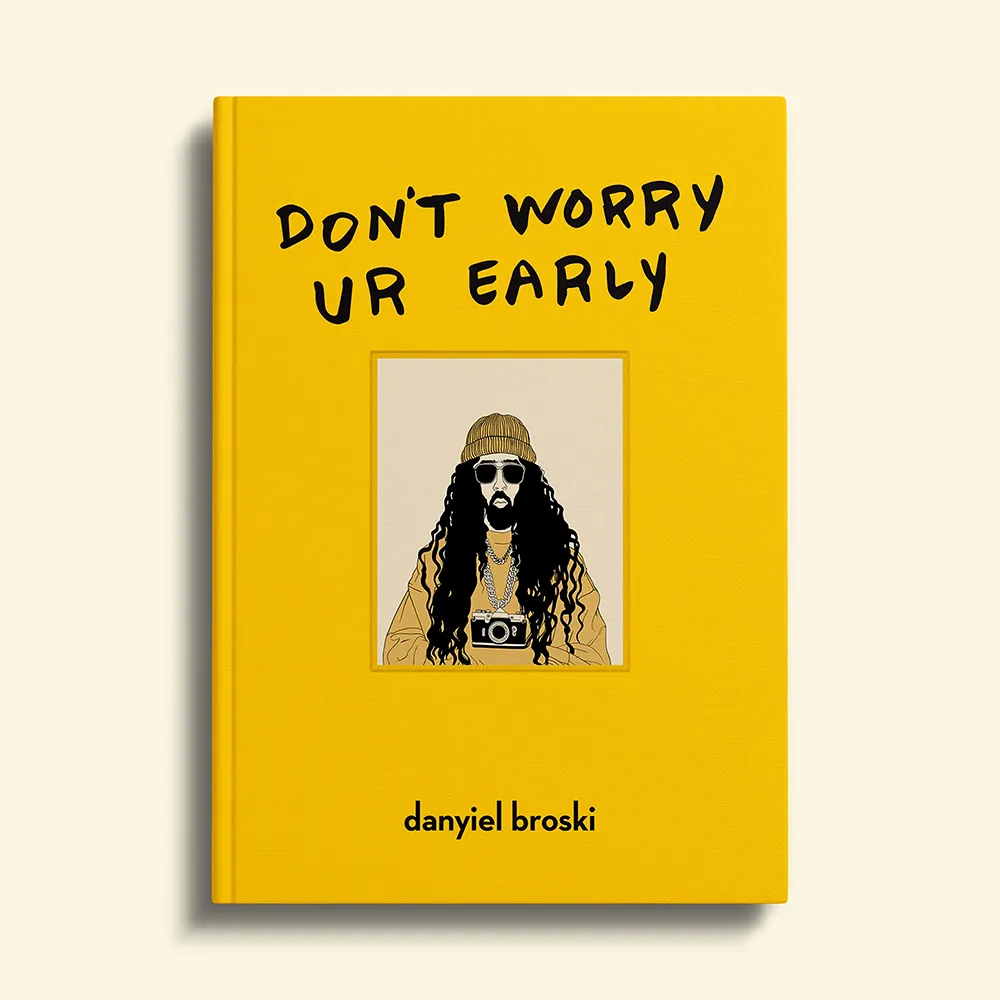 a yellow linen book featuring big, bold, black letters that read 'don't worry ur early.' an illustration of danyiel appears debossed in the center of the canvas. he is wearing his signature gold beanie, and gold dookie necklace with a camera attached to it like a pendant. danyiel broski's name appears below the illustration in simple, bold, black lettering.